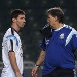Argentina’s national soccer team coach Gerardo Daniel Martino talks to player Lionel Messi during a training session ahead of their friendly soccer match in Hong Kong