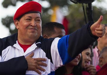Venezuela's President Hugo Chavez greets supporters during an election rally in Caracas July 26, 2012. REUTERS/Carlos Garcia Rawlins