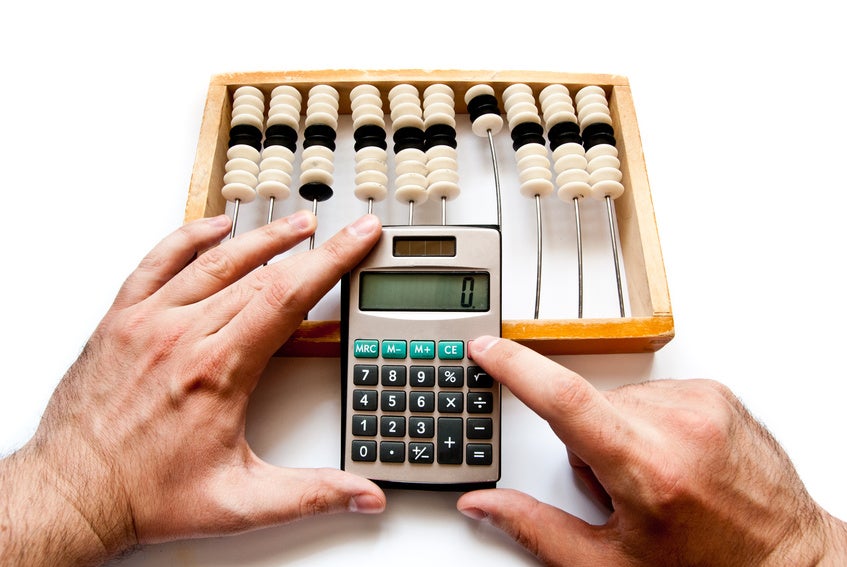 old abacus with calculator and hands