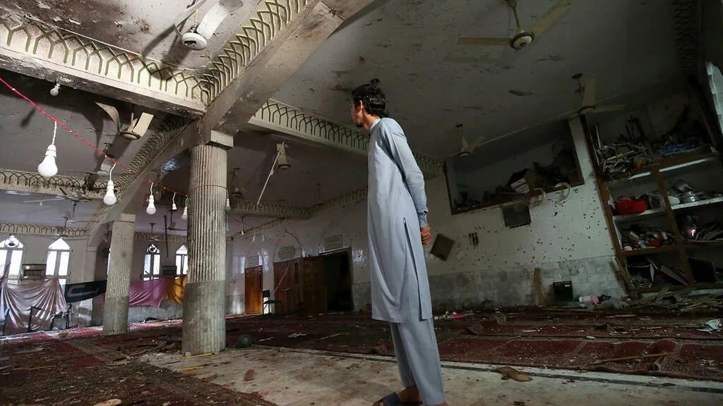 Musulmán chií pakistaní inspecciona las secuelas de la explosión de una bomba en una mezquita