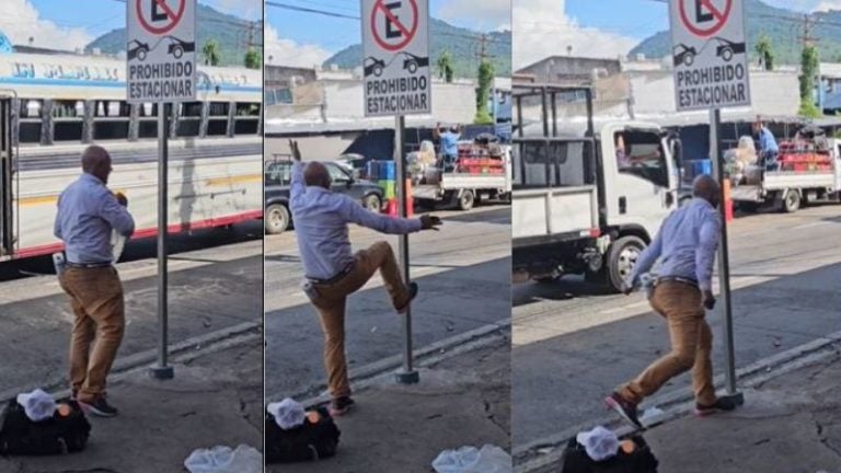 hombre pelea con una señal de transito